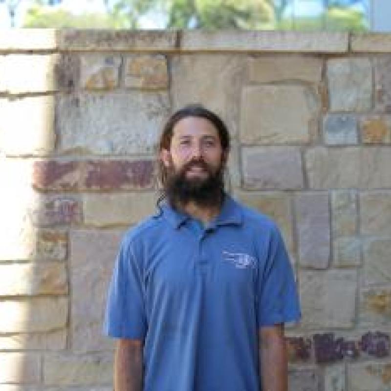 Ryan Walsh in front of brick wall